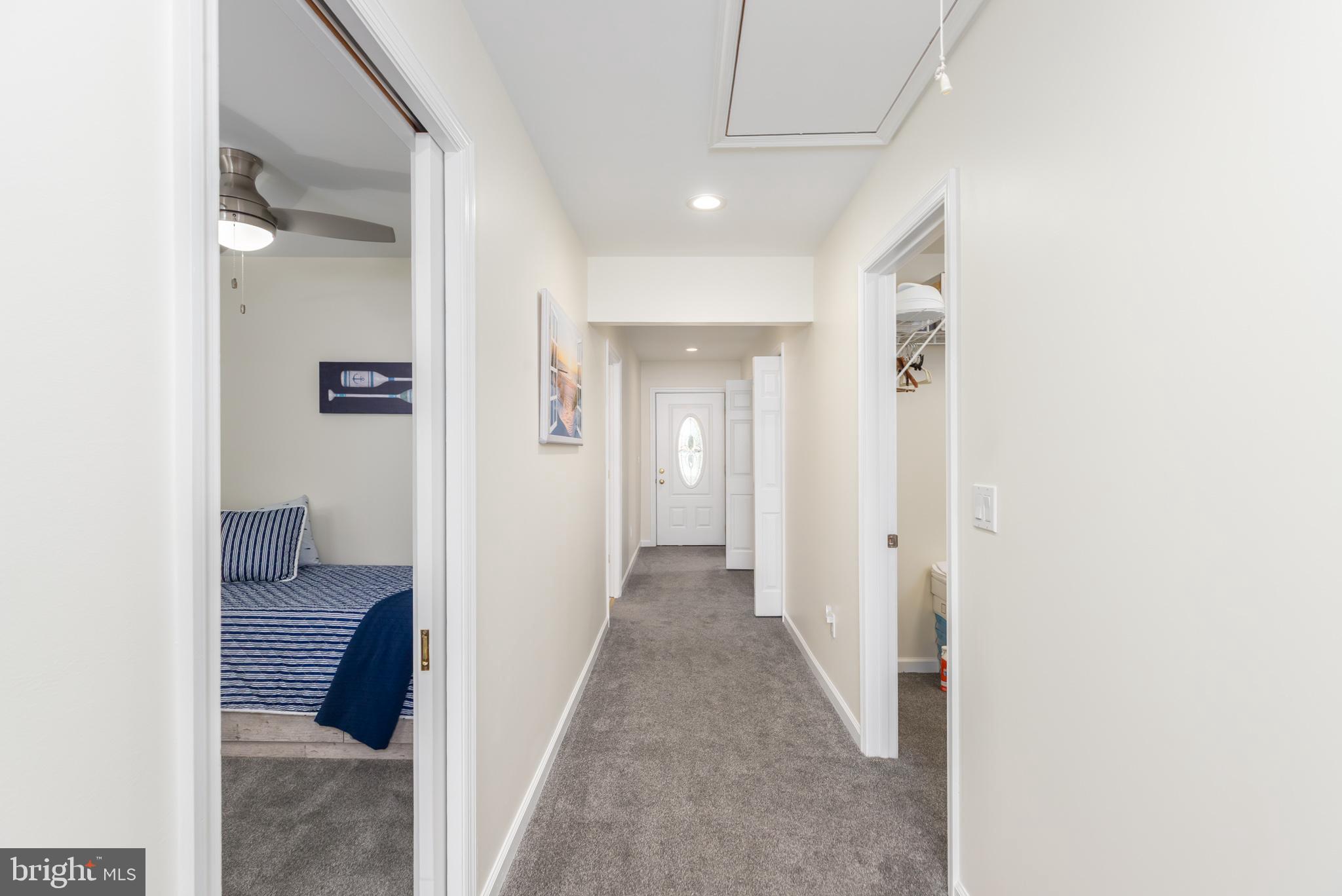 28016 Possum Point Road Millsboro, DE 19966 - Photo 39 of 70 a view of a hallway with wooden floor and staircase