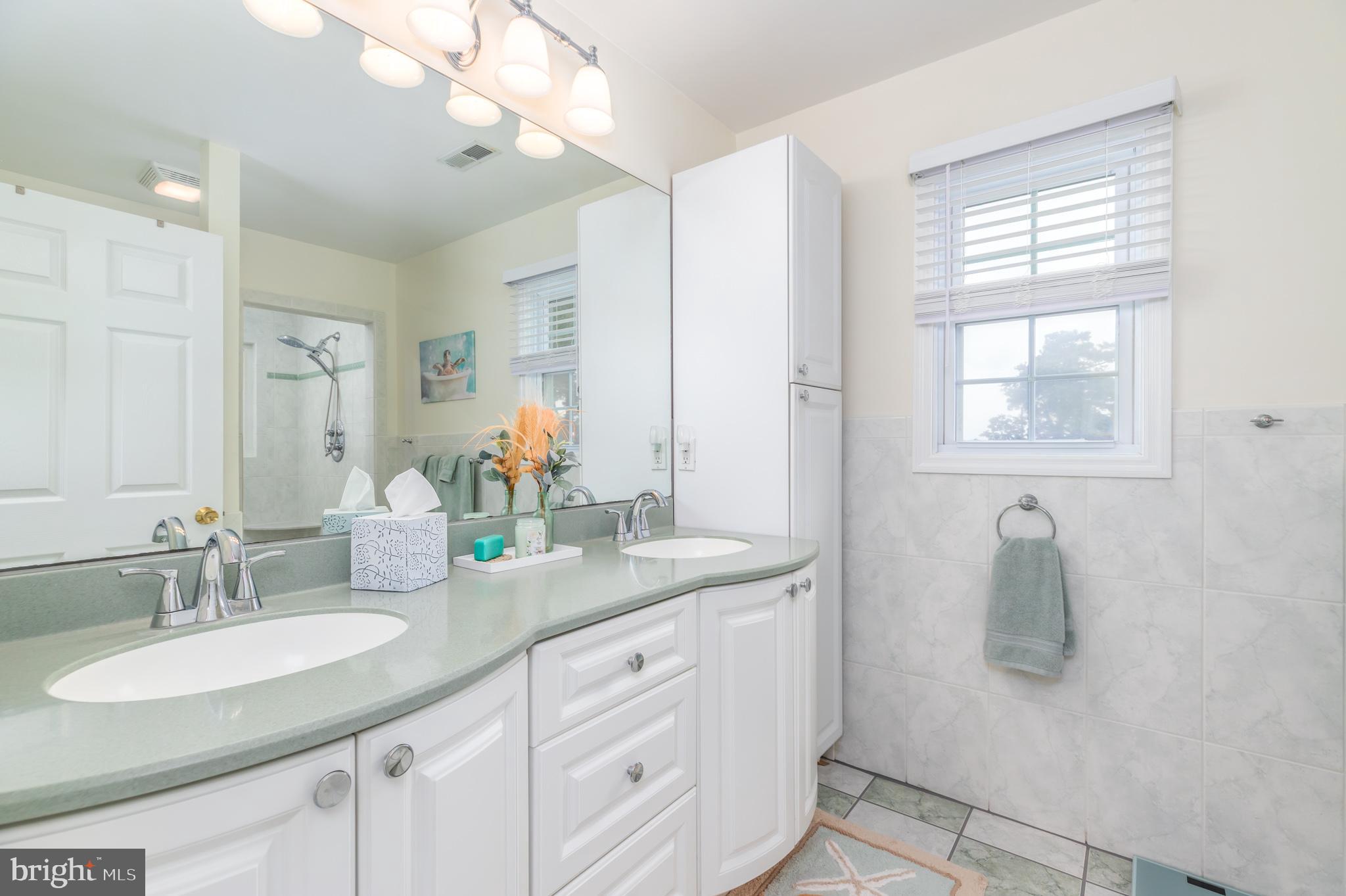 28016 Possum Point Road Millsboro, DE 19966 - Photo 44 of 70 a bathroom with a granite countertop sink vanity and mirror