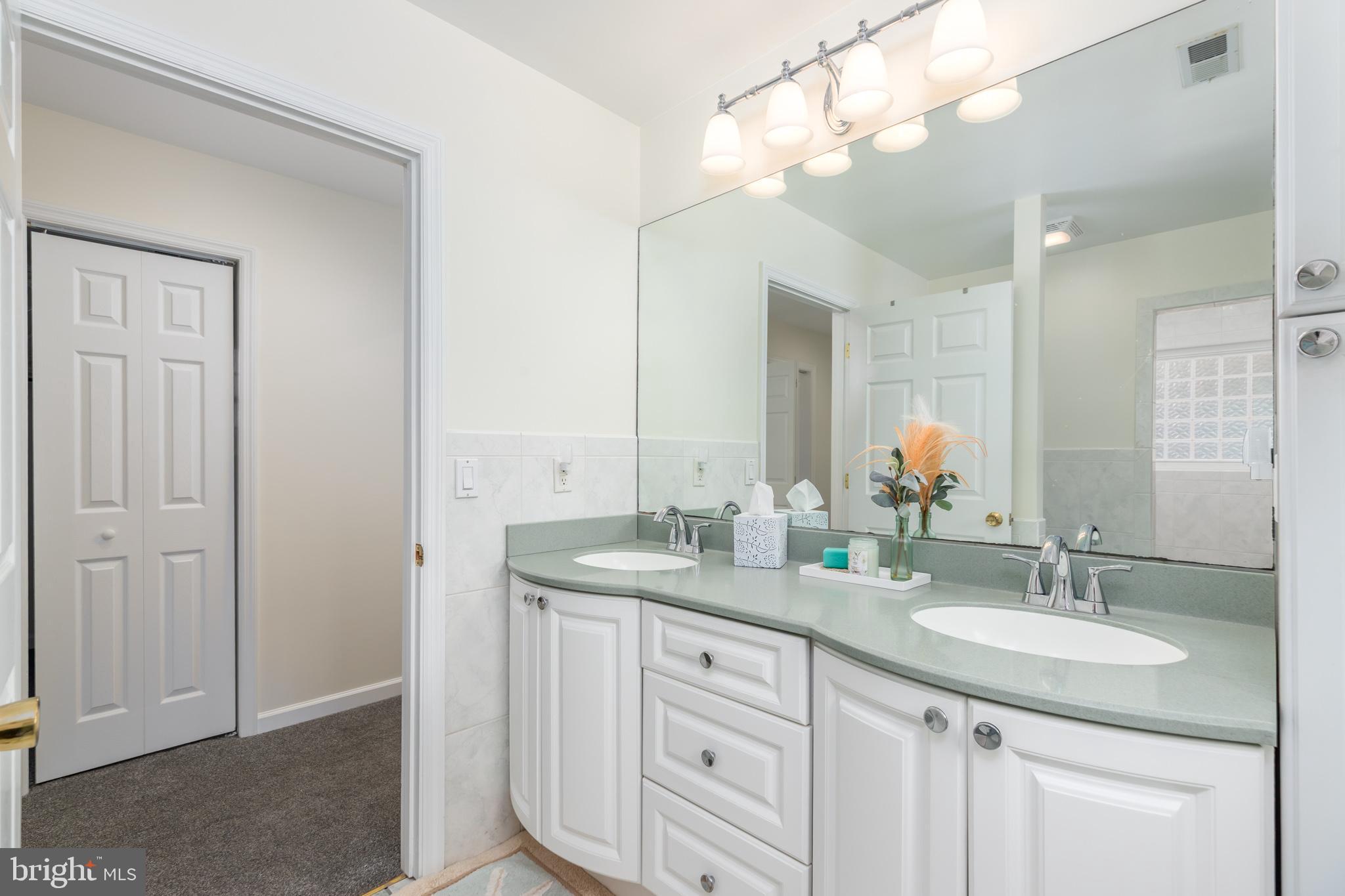 28016 Possum Point Road Millsboro, DE 19966 - Photo 46 of 70 a bathroom with a granite countertop sink a light fixture and a mirror