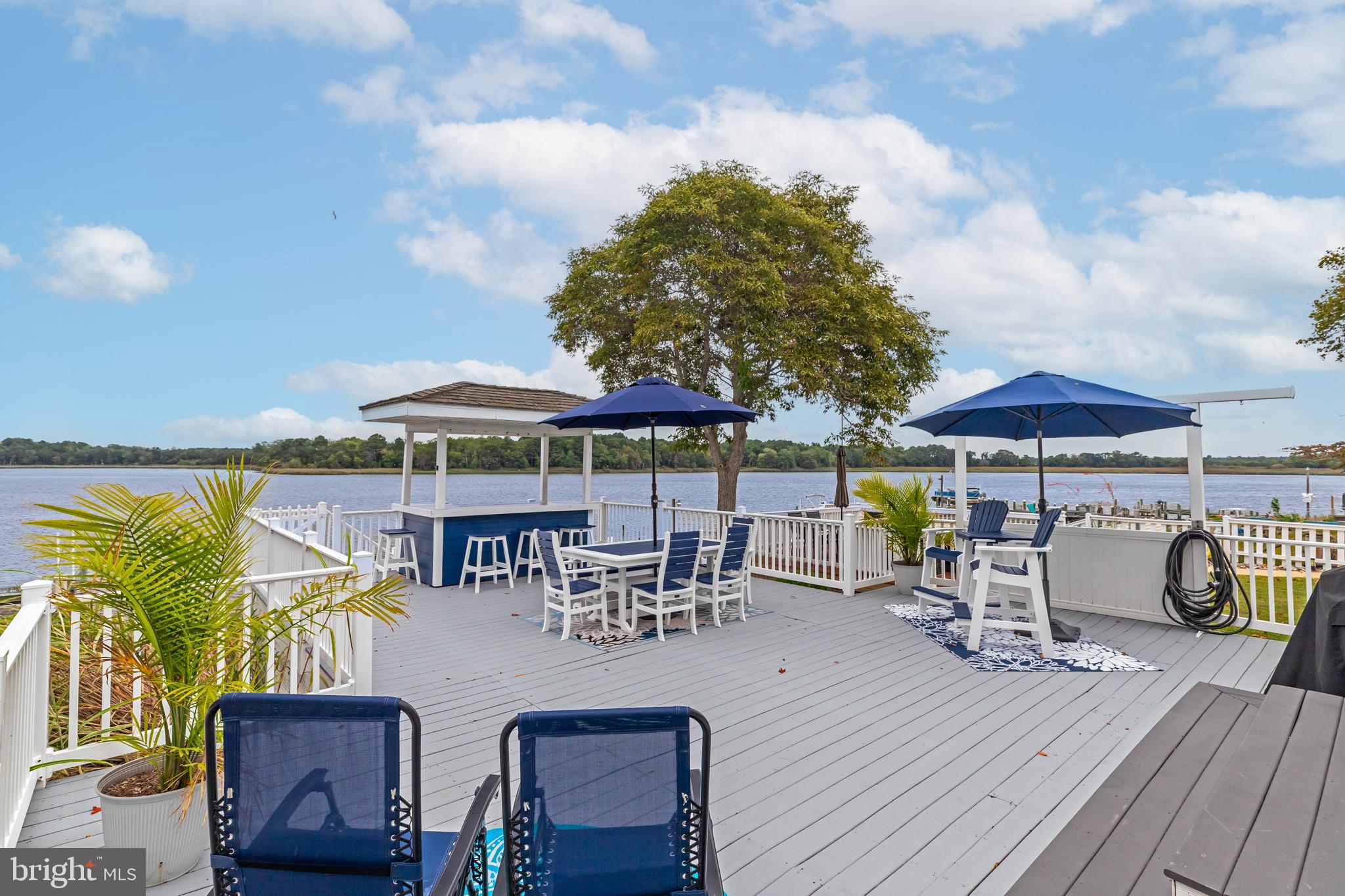 28016 Possum Point Road Millsboro, DE 19966 - Photo 52 of 70 an outdoor space with patio and umbrella