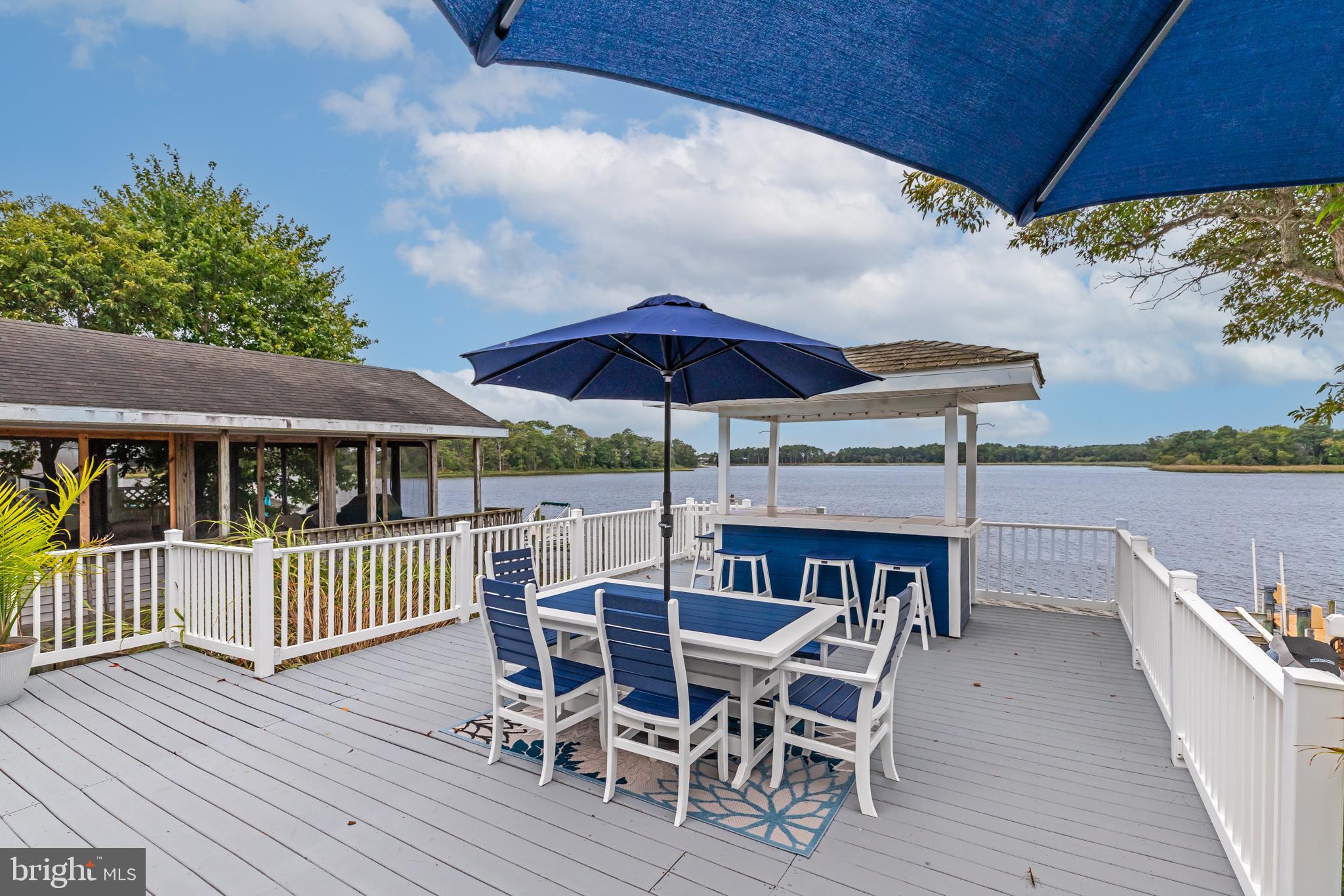28016 Possum Point Road Millsboro, DE 19966 - Photo 54 of 70 a view of a chair and table on the deck