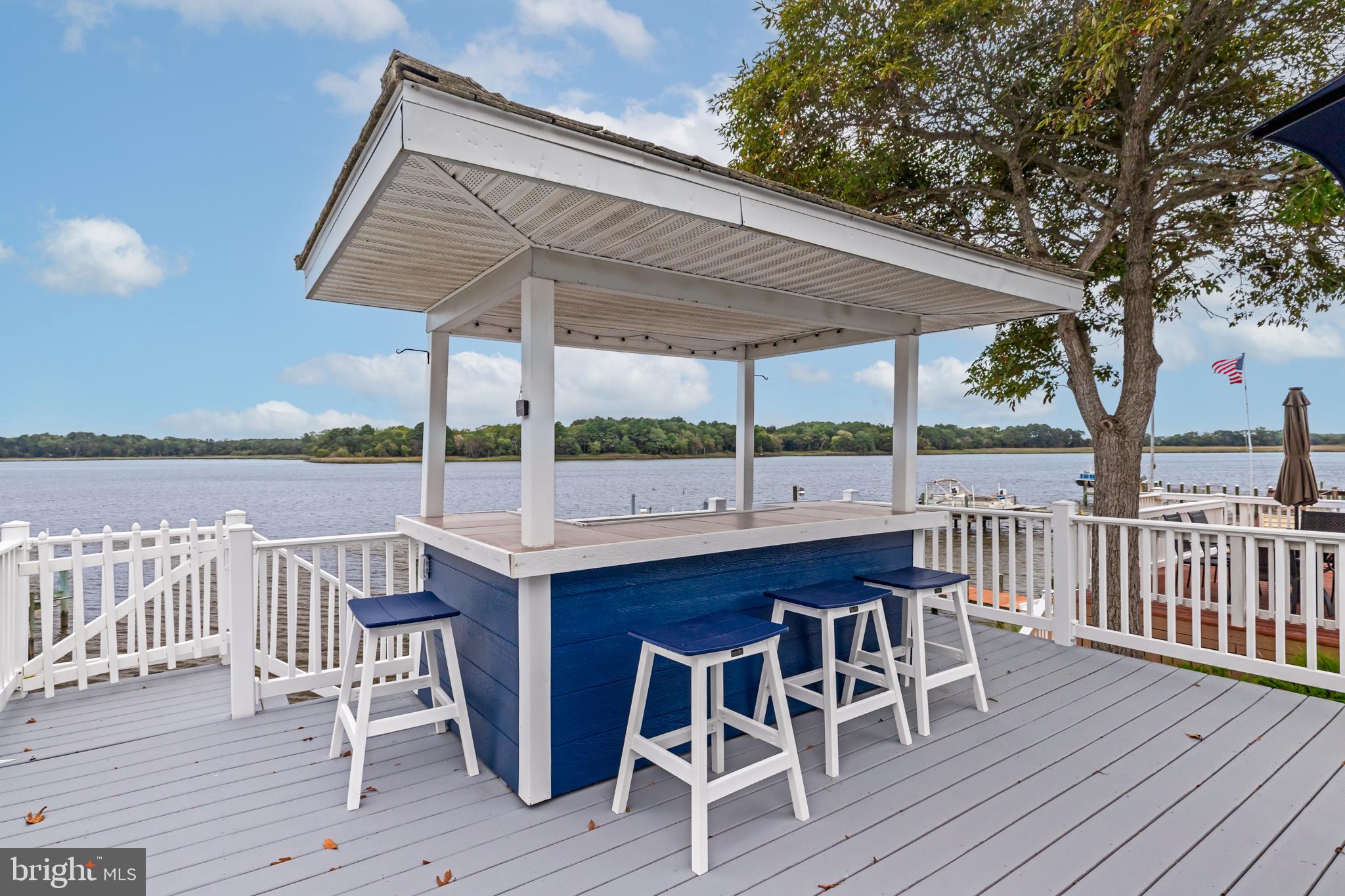 28016 Possum Point Road Millsboro, DE 19966 - Photo 56 of 70 a patio with wooden floor table and chairs
