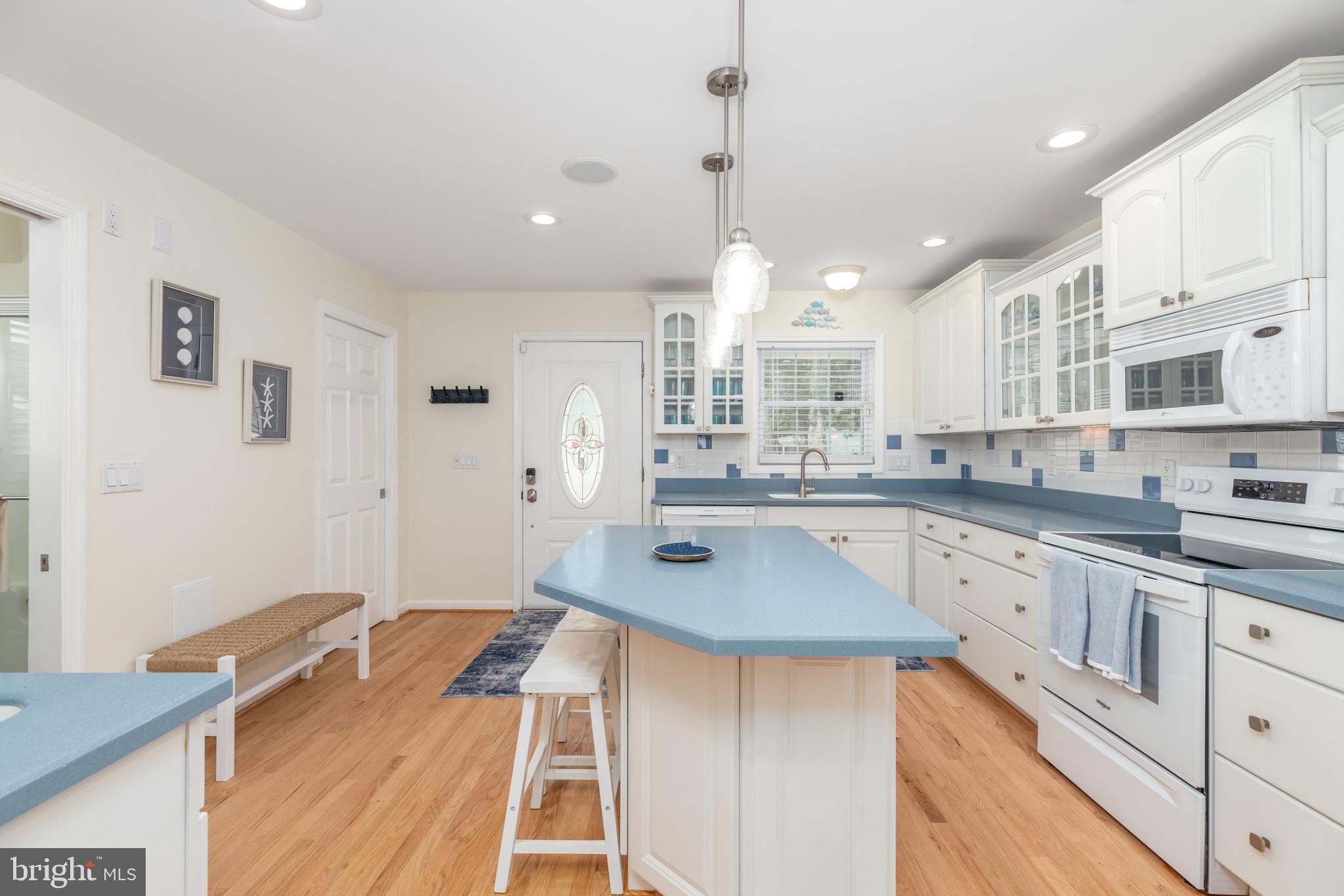 28016 Possum Point Road Millsboro, DE 19966 - Photo 8 of 70 a kitchen with stainless steel appliances granite countertop a sink stove and refrigerator