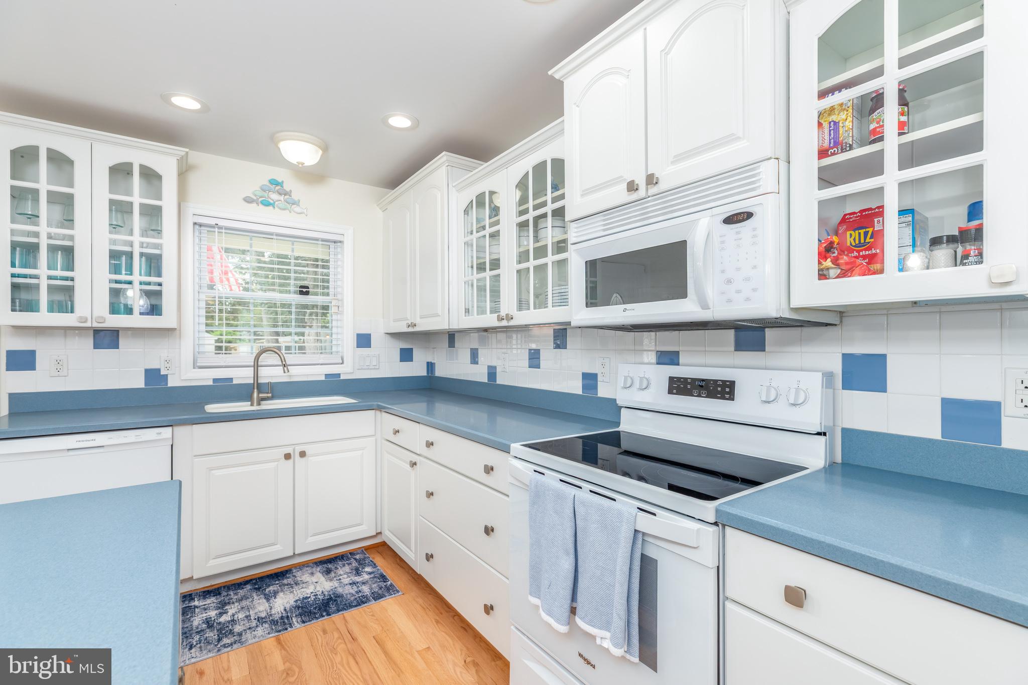 28016 Possum Point Road Millsboro, DE 19966 - Photo 10 of 70 a kitchen with stainless steel appliances granite countertop a sink and cabinets