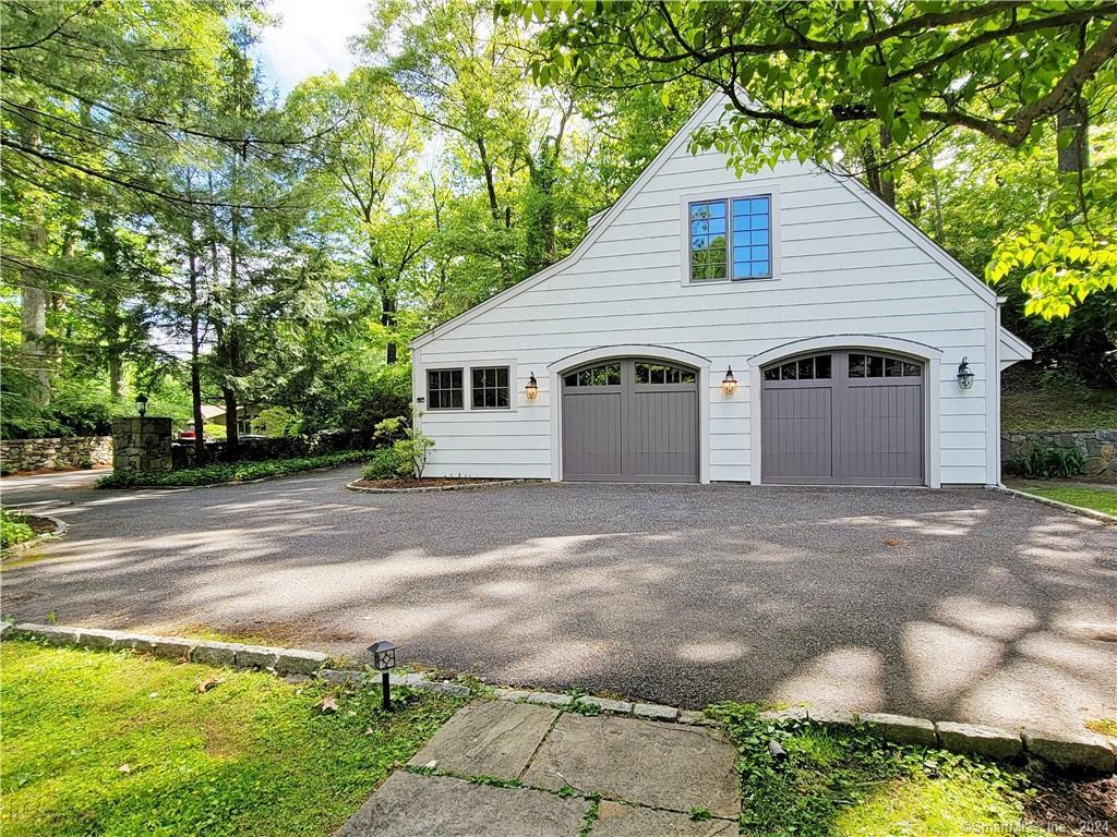 22 Ketcham Road Ridgefield, CT 06877 - Photo 4 of 40 a view of a white house with a yard and large trees
