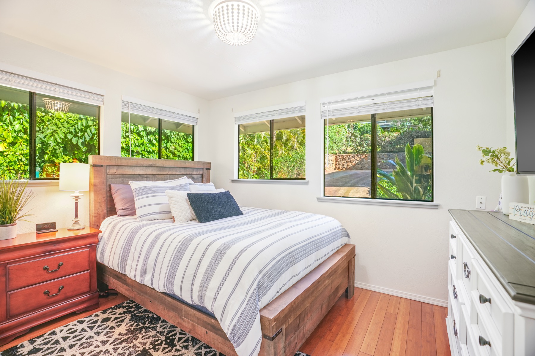 4940 A Hauaala Road Kapaa, HI 96746 - Photo 12 of 22 a bedroom with a large bed and a large window with outer view