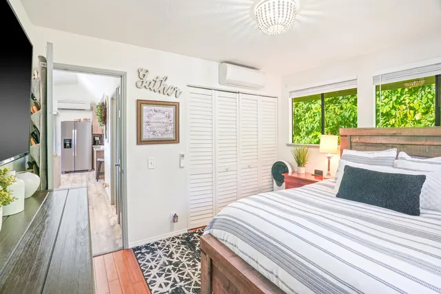 a bedroom with a bed and a large window