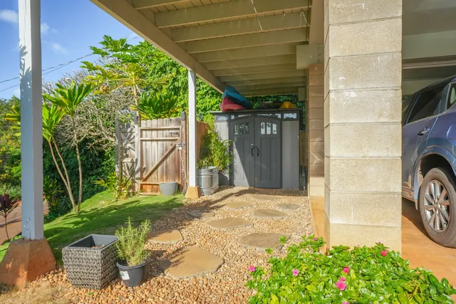 a view of a backyard with table and chairs and a barbeque