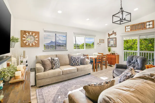 a living room with furniture or couch and a large window