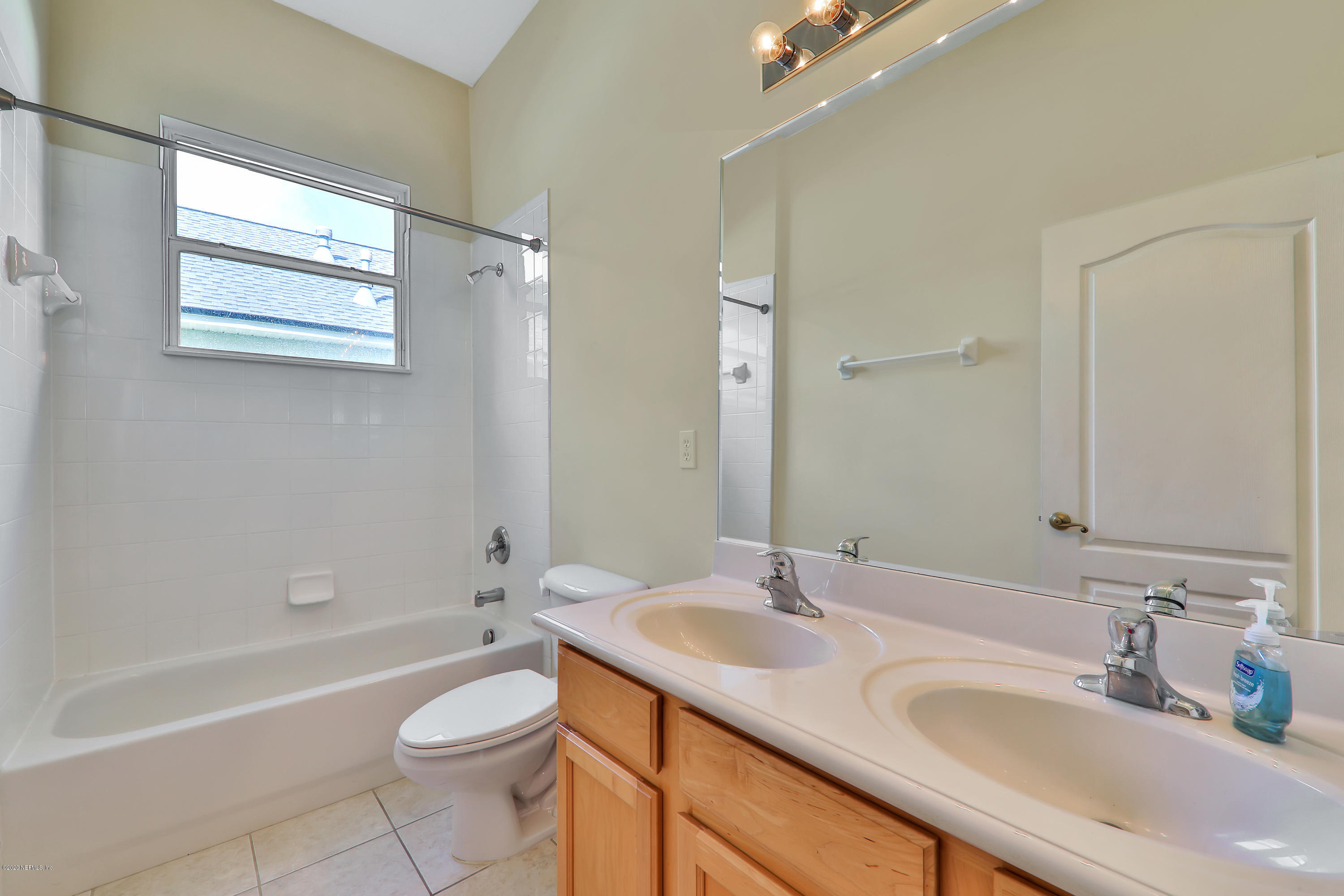 804 Riley Lane St. Augustine, FL 32095 - Photo 15 of 35 a bathroom with a granite countertop sink toilet mirror and bathtub