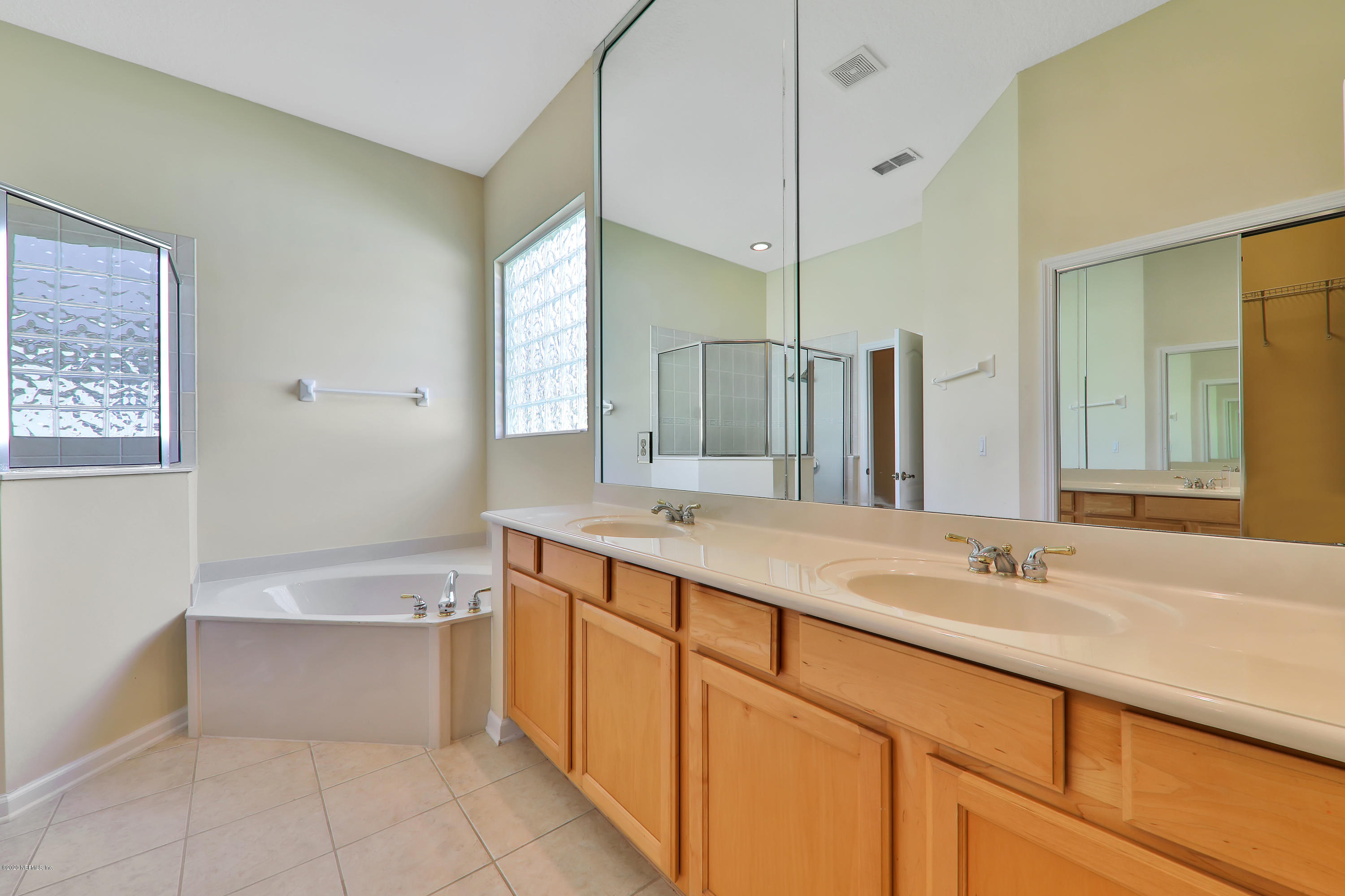 804 Riley Lane St. Augustine, FL 32095 - Photo 20 of 35 a bathroom with a tub sink and mirror