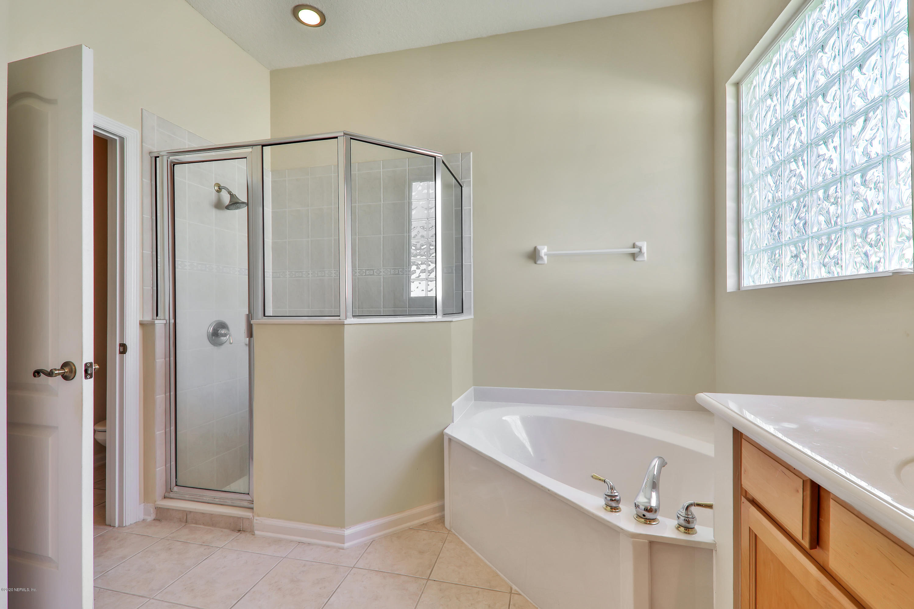 804 Riley Lane St. Augustine, FL 32095 - Photo 21 of 35 a bathroom with a bathtub and a shower