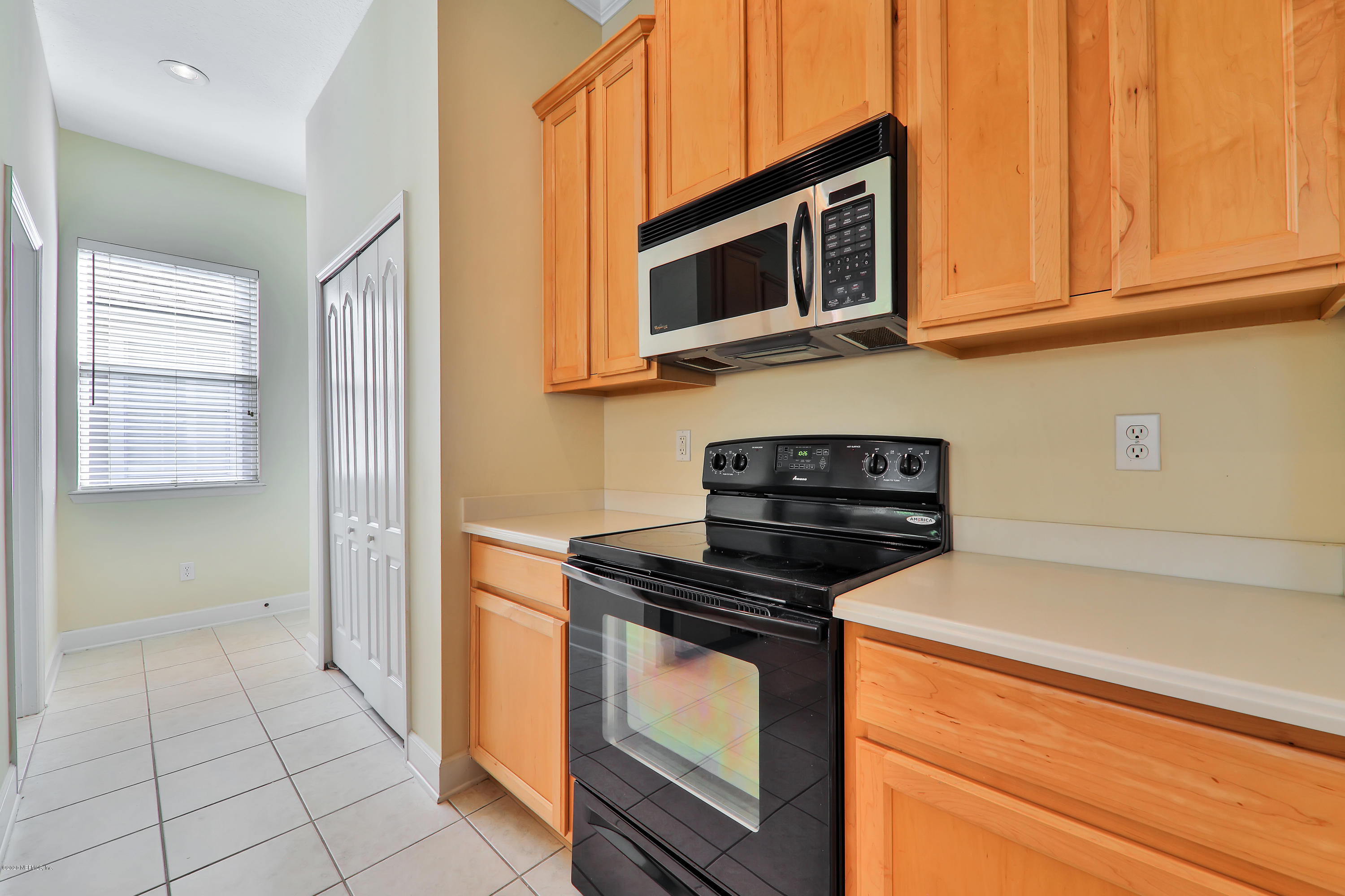 804 Riley Lane St. Augustine, FL 32095 - Photo 27 of 35 a kitchen with stainless steel appliances granite countertop a stove microwave and cabinets