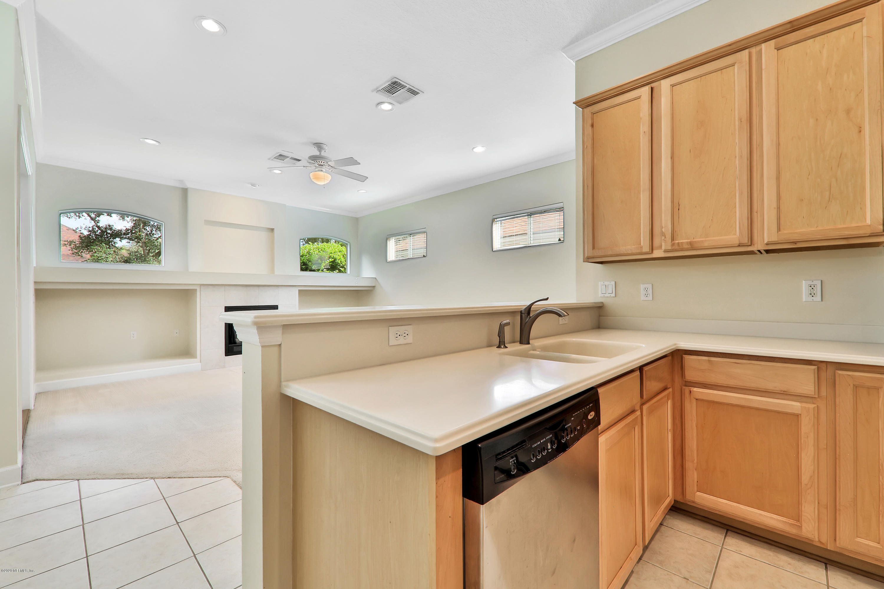 804 Riley Lane St. Augustine, FL 32095 - Photo 29 of 35 a kitchen with stainless steel appliances granite countertop a sink and dishwasher with white cabinets