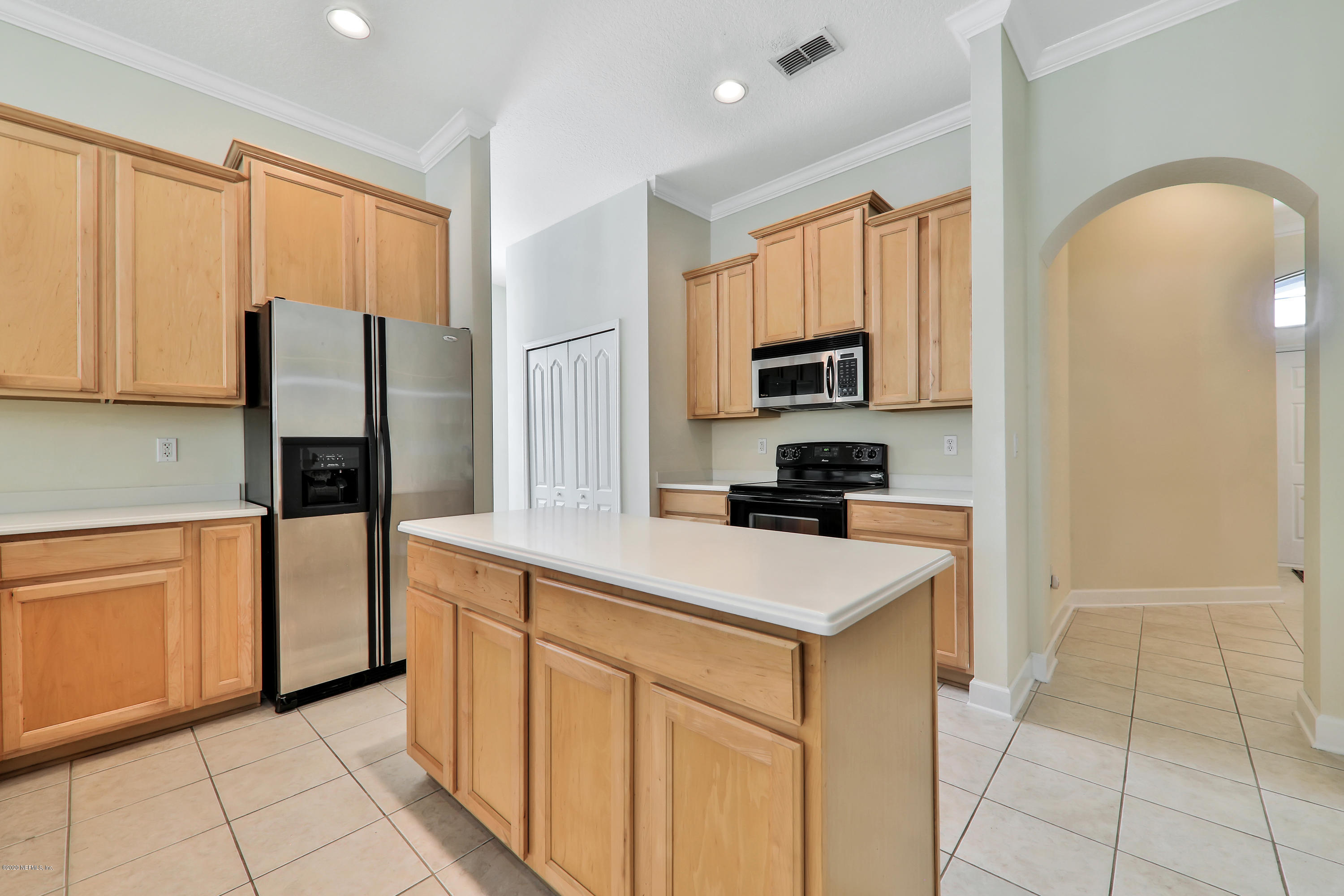 804 Riley Lane St. Augustine, FL 32095 - Photo 30 of 35 a kitchen with stainless steel appliances granite countertop a refrigerator and a stove top oven