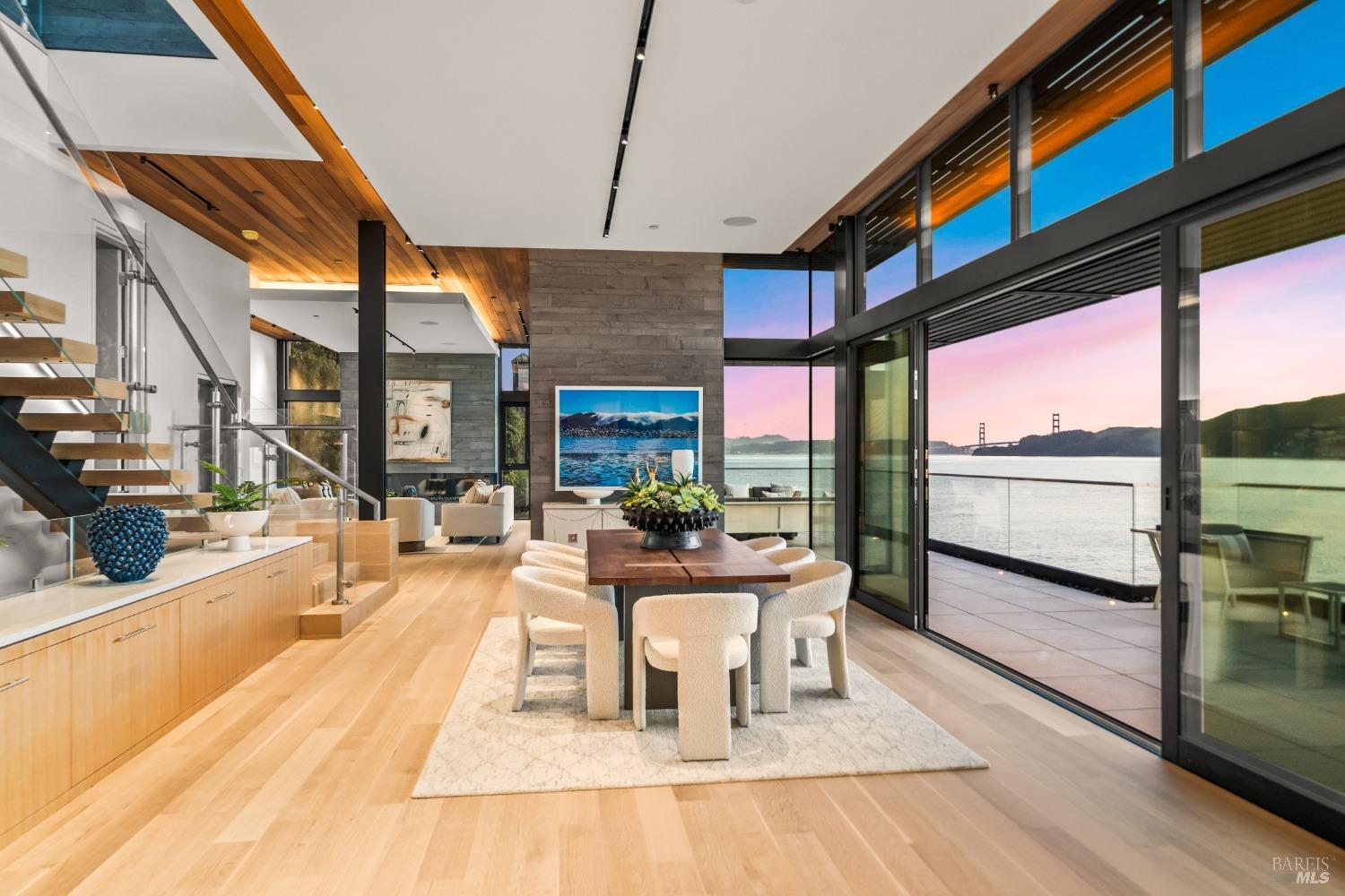 46 Cliff Road Belvedere, CA 94920 - Photo 2 of 42 a dining room with furniture a fireplace and wooden floor