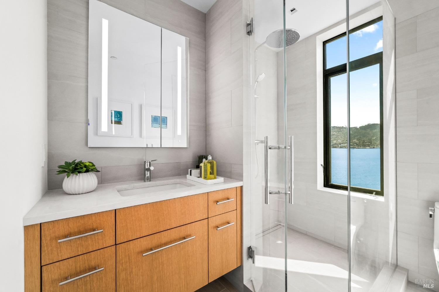 46 Cliff Road Belvedere, CA 94920 - Photo 21 of 42 a bathroom with a granite countertop sink mirror and window