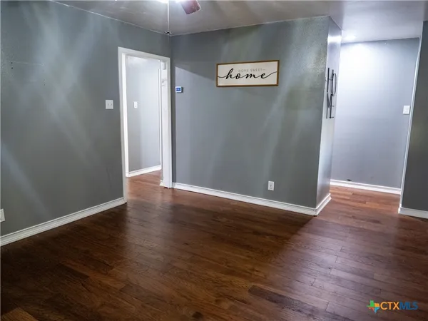 an empty room with wooden floor and closet