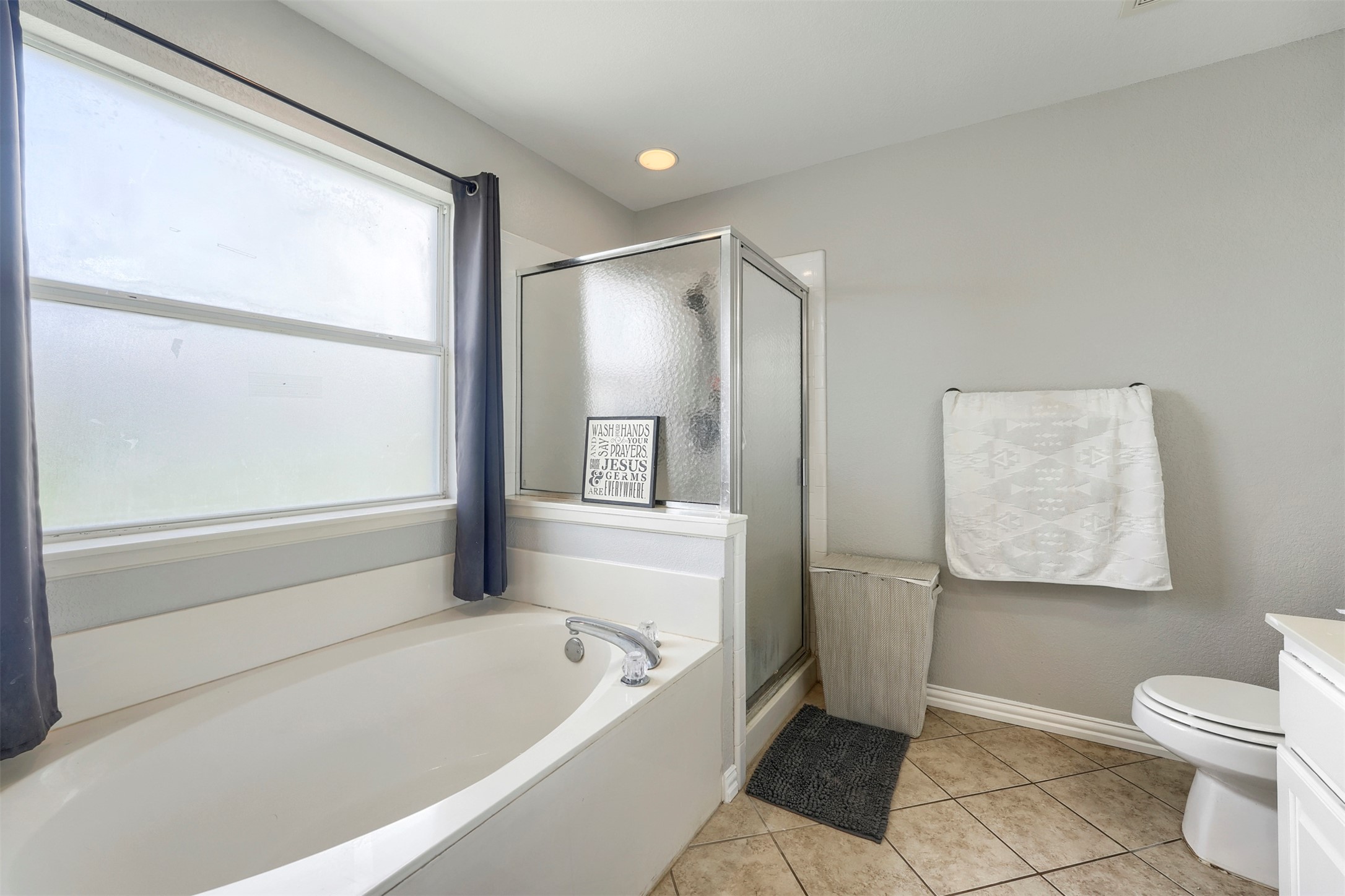1105 2nd Street Jarrell, TX 76537 - Photo 14 of 27 Relax in this well-appointed bathroom featuring a soaking tub and walk-in shower.