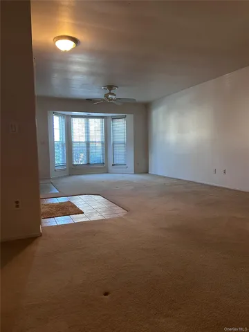 an empty room with floor to ceiling windows
