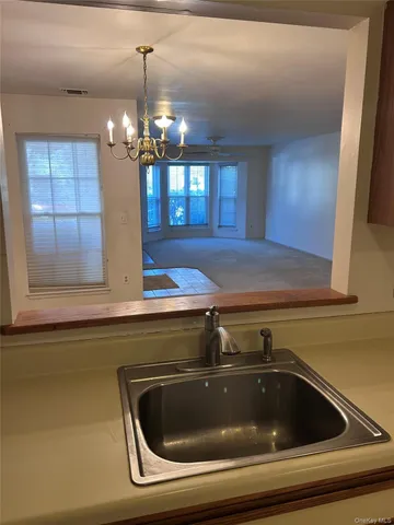 a kitchen with a sink and chandelier