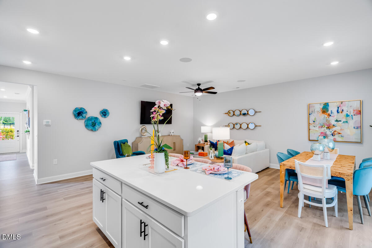 8767 Wardle Court Wake Forest, NC 27587 - Photo 11 of 32 a view of a dining room with furniture and wooden floor