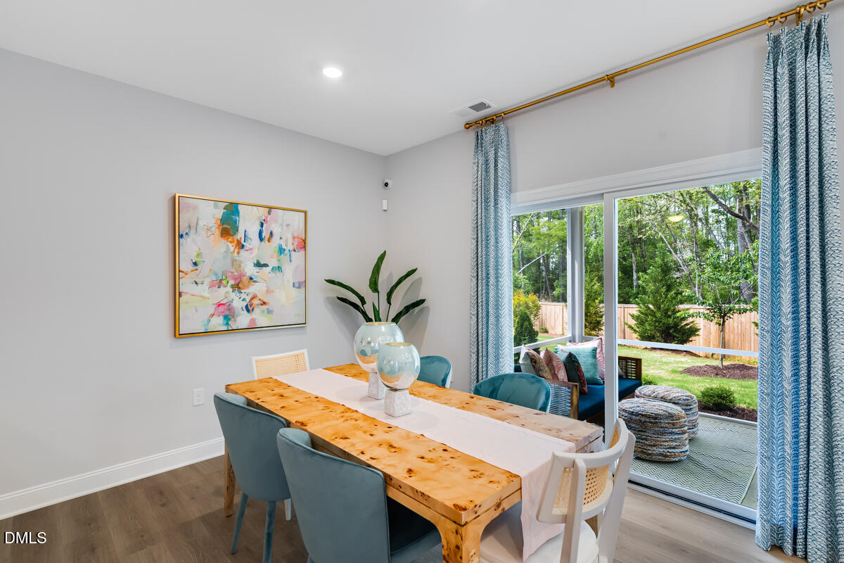 8767 Wardle Court Wake Forest, NC 27587 - Photo 12 of 32 a dining room with furniture and window