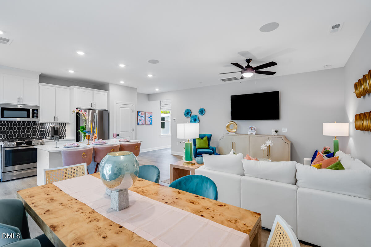 8767 Wardle Court Wake Forest, NC 27587 - Photo 13 of 32 a living room with furniture and a flat screen tv