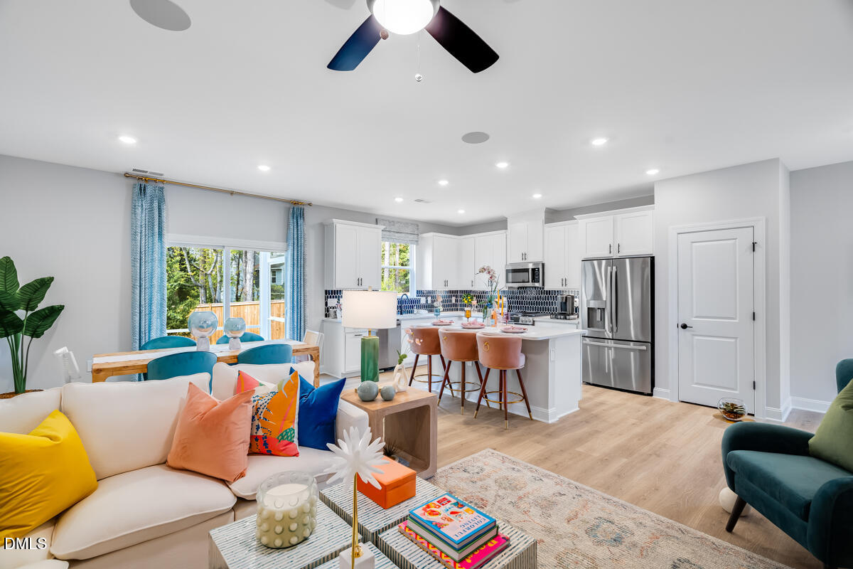 8767 Wardle Court Wake Forest, NC 27587 - Photo 15 of 32 a living room with stainless steel appliances furniture and a large window