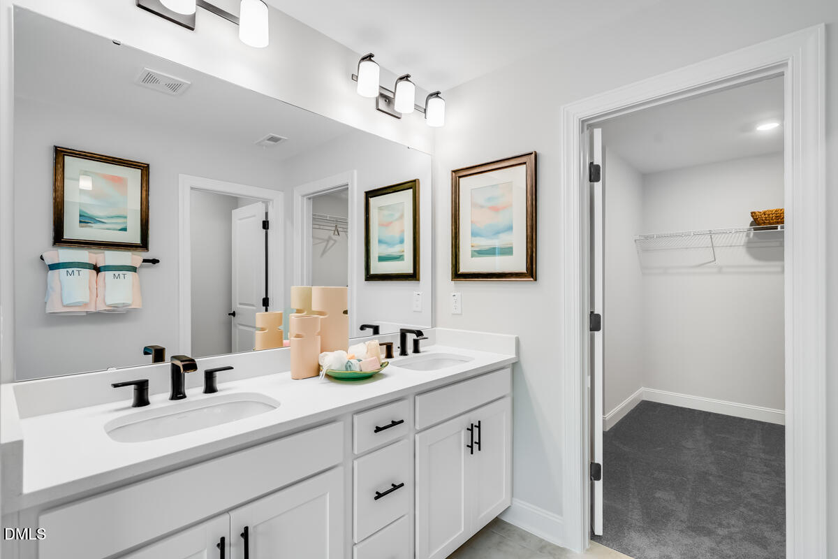 8767 Wardle Court Wake Forest, NC 27587 - Photo 17 of 32 a bathroom with a sink double vanity and a mirror