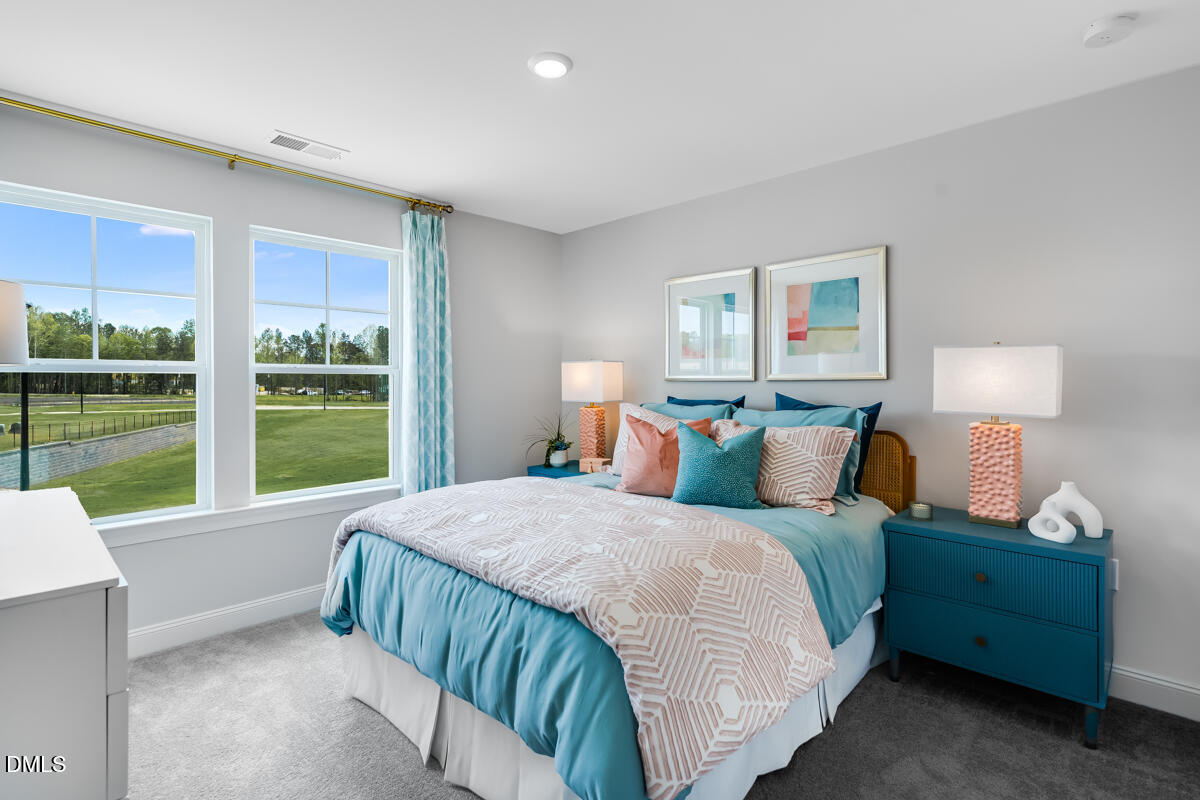 8767 Wardle Court Wake Forest, NC 27587 - Photo 18 of 32 a bedroom with a bed and a large window