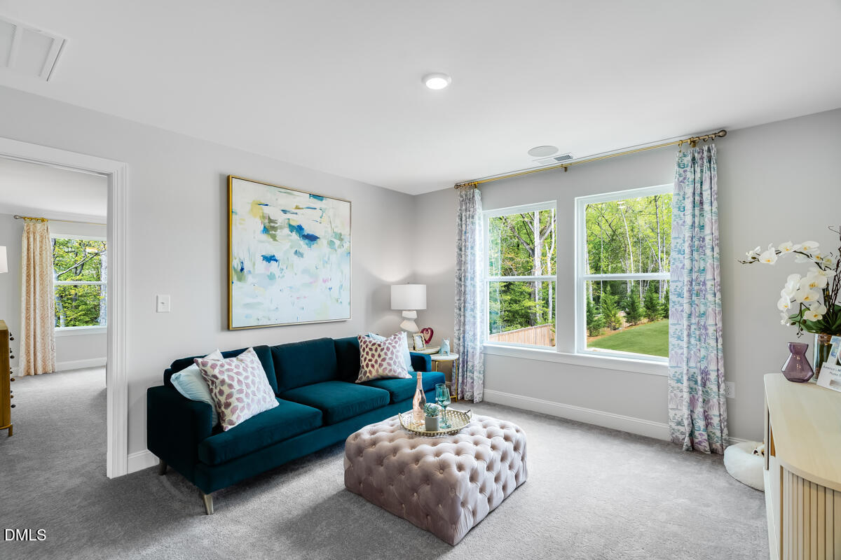 8767 Wardle Court Wake Forest, NC 27587 - Photo 22 of 32 a living room with furniture and a large window