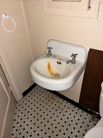 a living room with a chair and large window