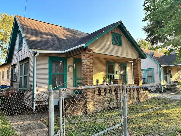 a view of a house with wooden fence