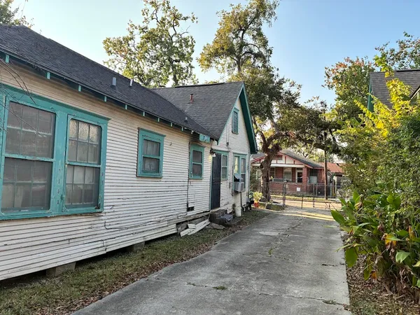 a front view of a house with a tree