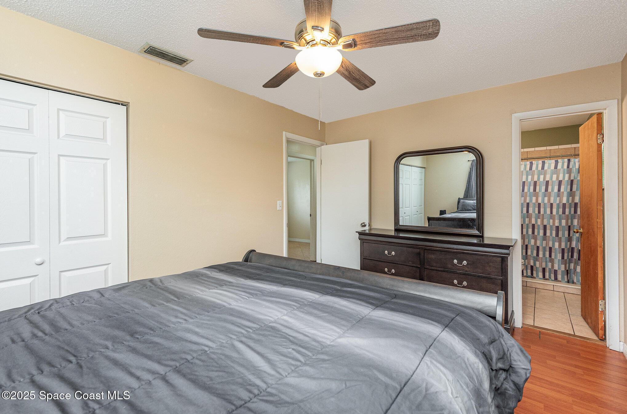 5930 Ackard Avenue Cocoa, FL 32927 - Photo 11 of 22 a bedroom with a bed and a chandelier