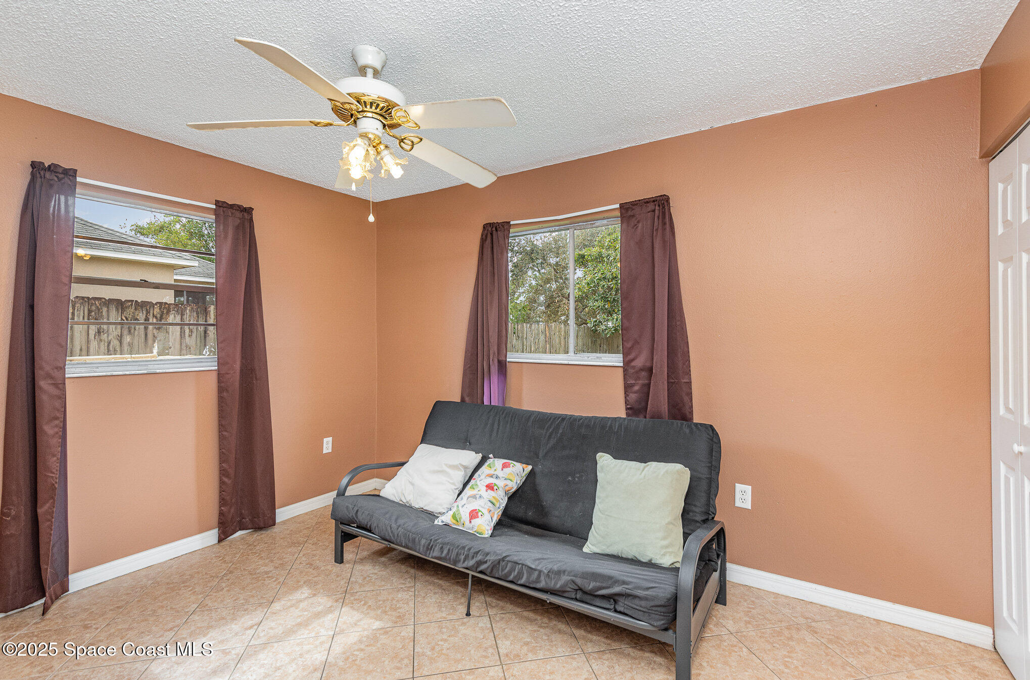 5930 Ackard Avenue Cocoa, FL 32927 - Photo 14 of 22 a living room with furniture and a chandelier