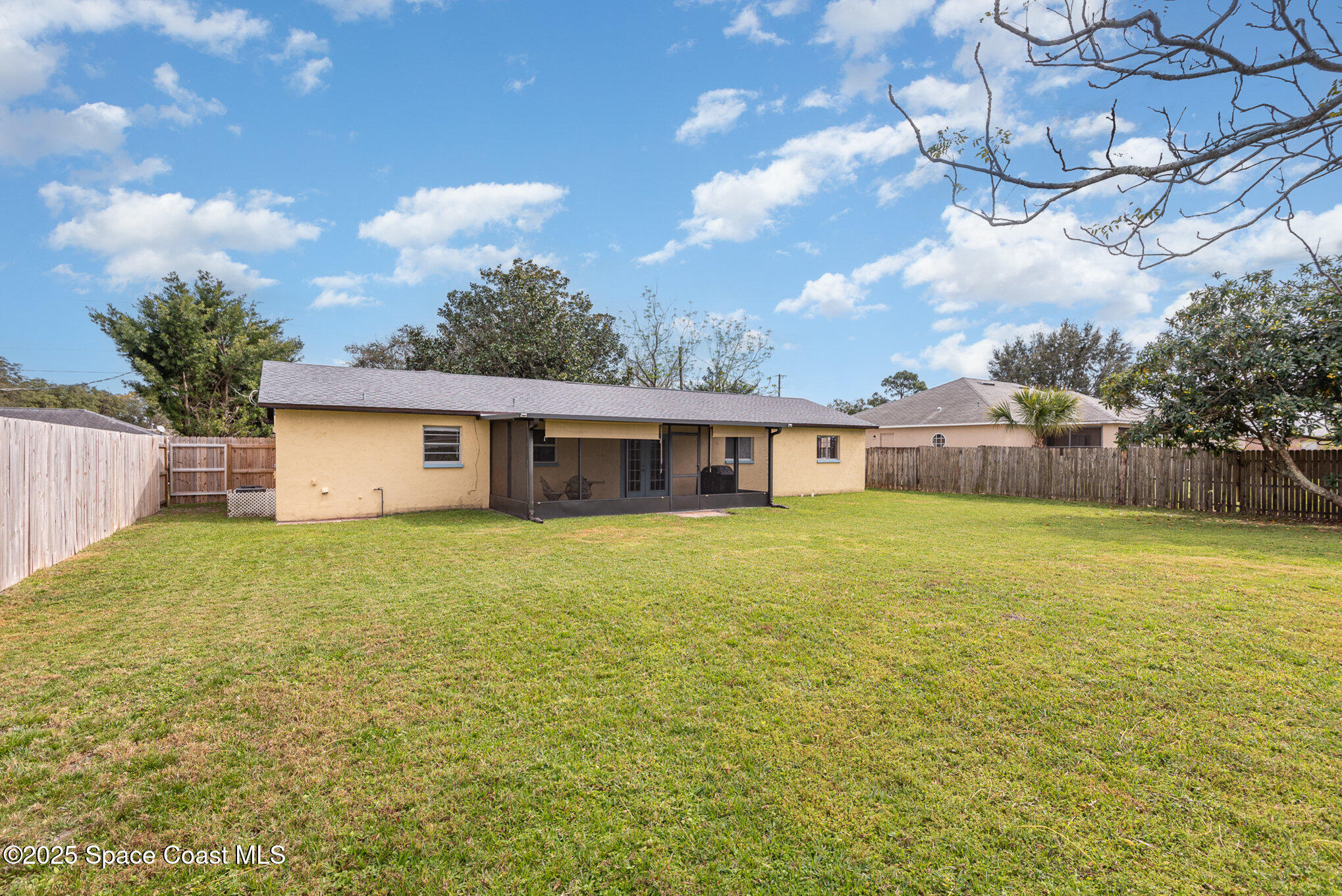 5930 Ackard Avenue Cocoa, FL 32927 - Photo 21 of 22 a front view of house with yard and trees in the background