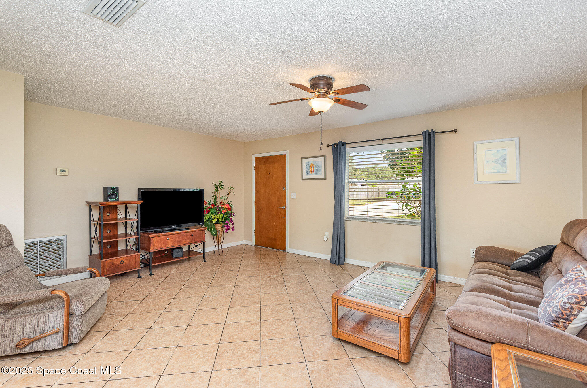 5930 Ackard Avenue Cocoa, FL 32927 - Photo 3 of 22 a living room with furniture and a flat screen tv
