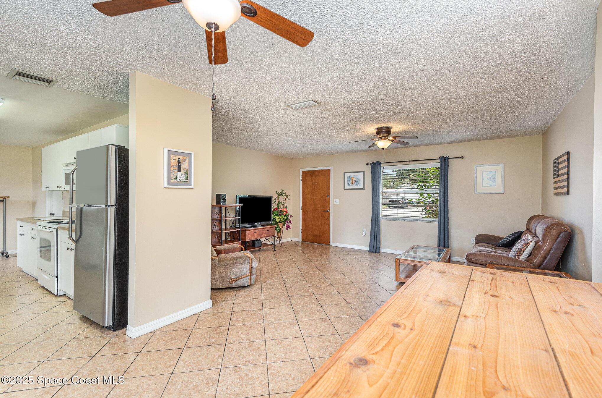 5930 Ackard Avenue Cocoa, FL 32927 - Photo 6 of 22 a spacious bedroom with a bed and a chandelier