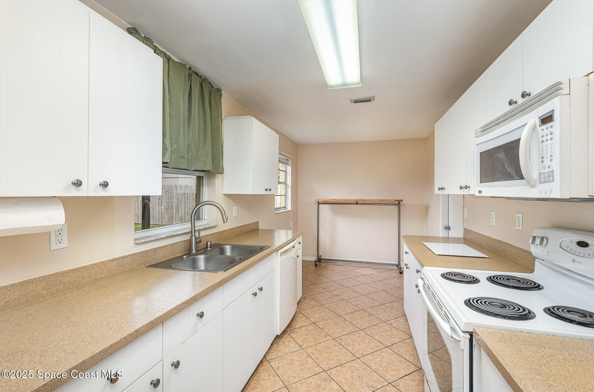 5930 Ackard Avenue Cocoa, FL 32927 - Photo 8 of 22 a kitchen that has a sink and a stove