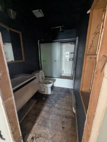 a living room with a toilet a rug and a large window