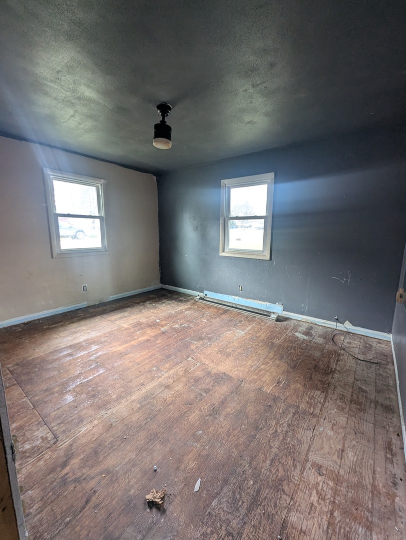 20 Academy Street German Valley, IL 61039 - Photo 4 of 9 an empty room with windows and ceiling fan view