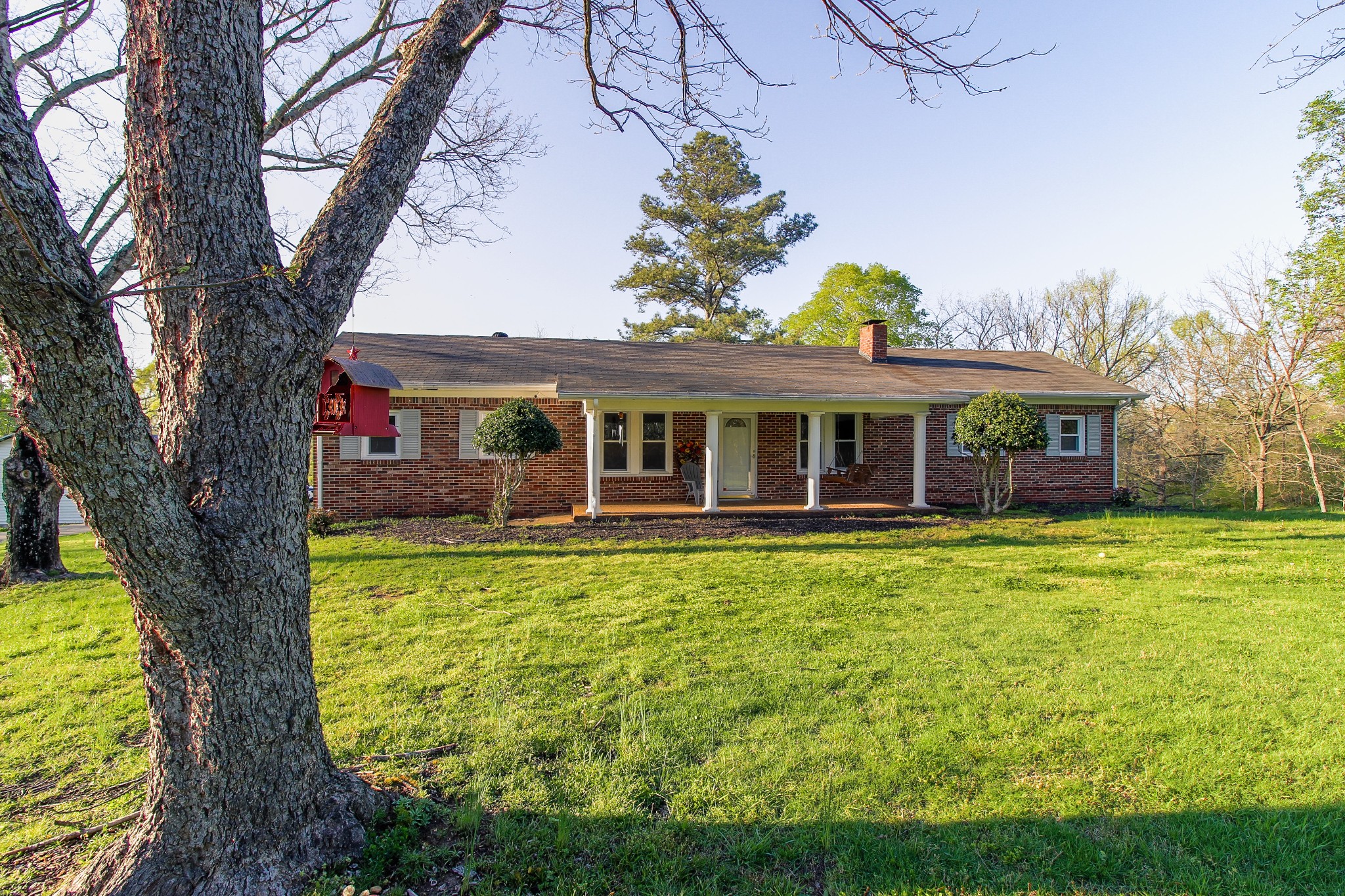 a front view of a house with a garden