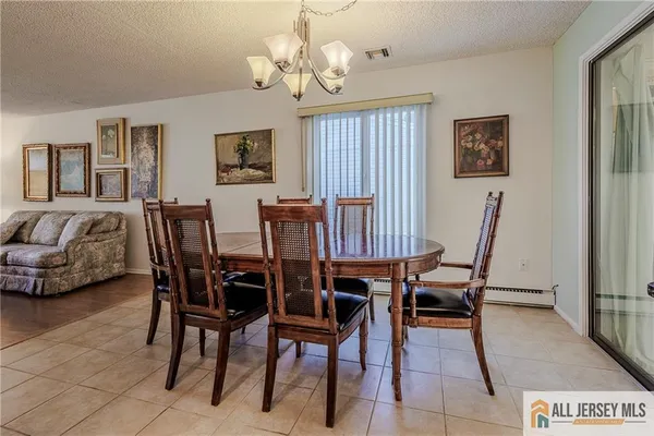a view of a dining room with furniture and a chandelier