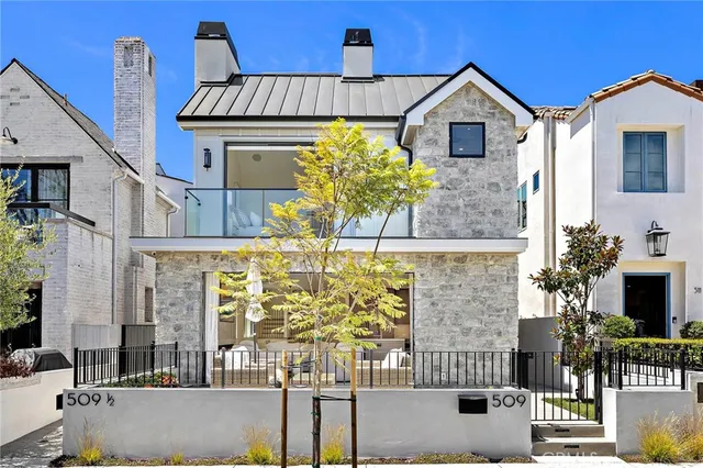 a front view of a house with outdoor seating