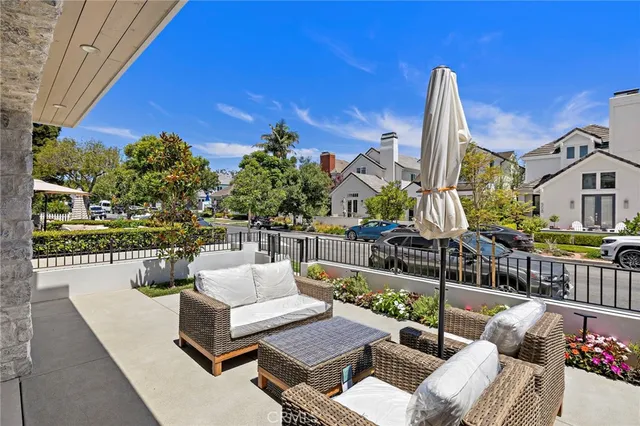 a view of a patio with couches dining table and chairs with wooden floor