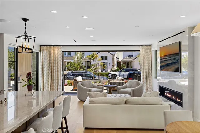 a living room with furniture a flat screen tv and a large window