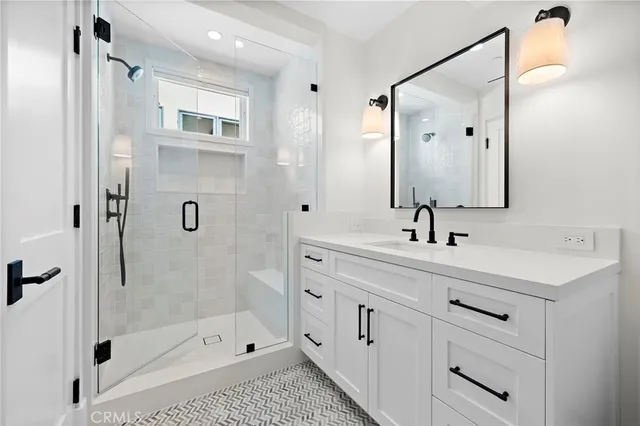 a bathroom with a shower sink and mirror