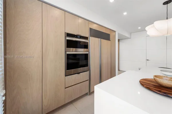 a kitchen with stainless steel appliances a refrigerator and cabinets